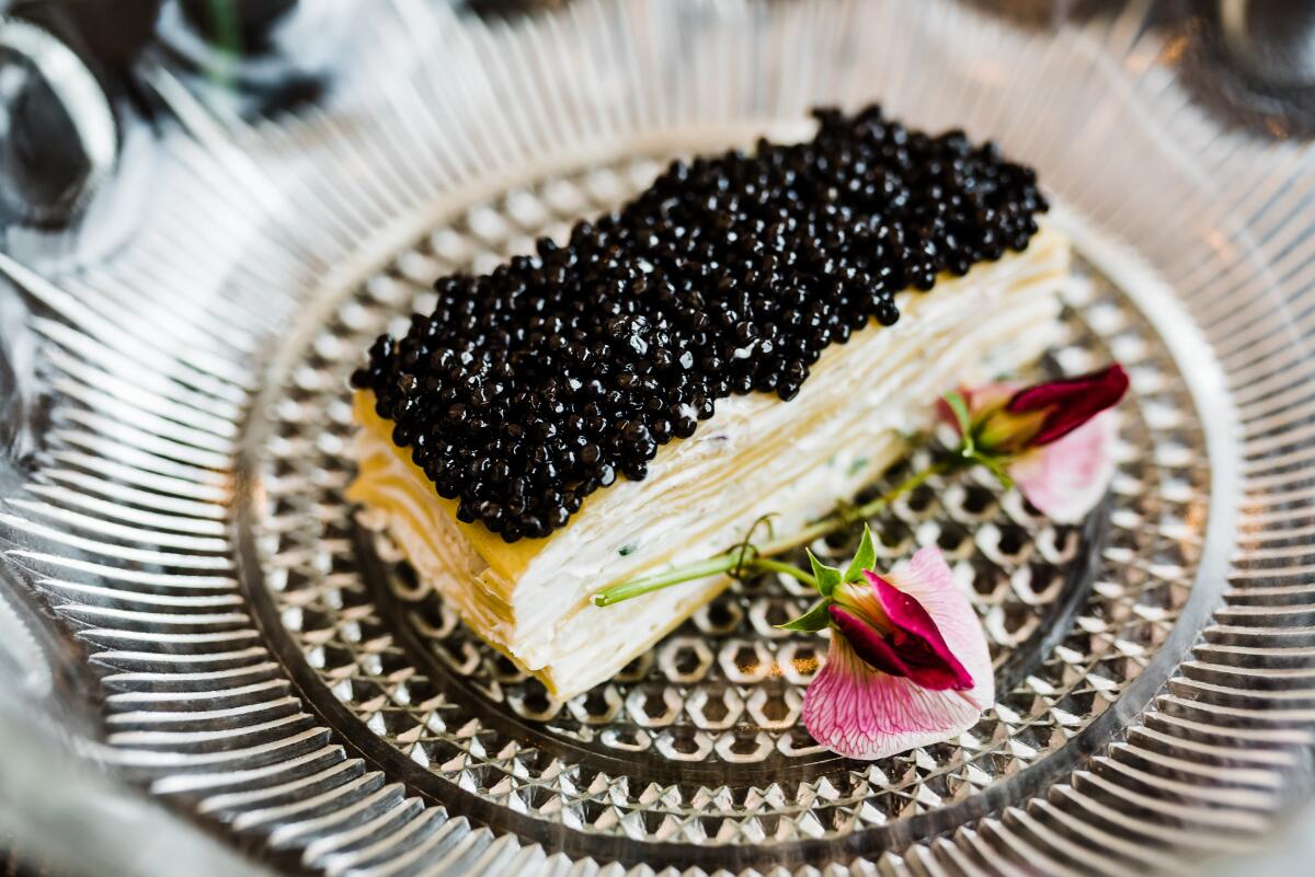 A slice of lasagna topped with caviar