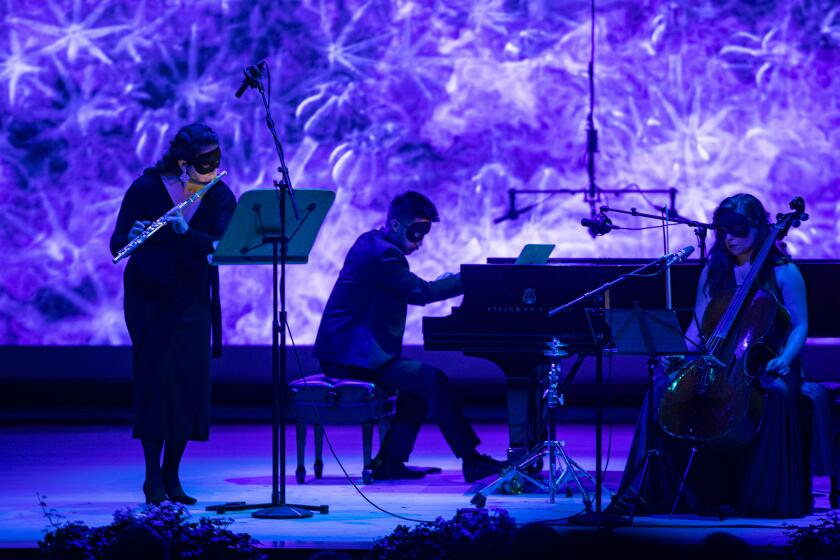 LA JOLLA, CA - AUGUST 4, 2019: While wearing masks, pianist Conrad Tao, flutist Rose Lombardo and cellist Alisa Weilerstein perform Crumb's Voice of Whales during Summerfest opening weekend at the new concert hall, The Conrad, on August 4, 2019 in La Jolla, California. (Gina Ferazzi/Los AngelesTimes)