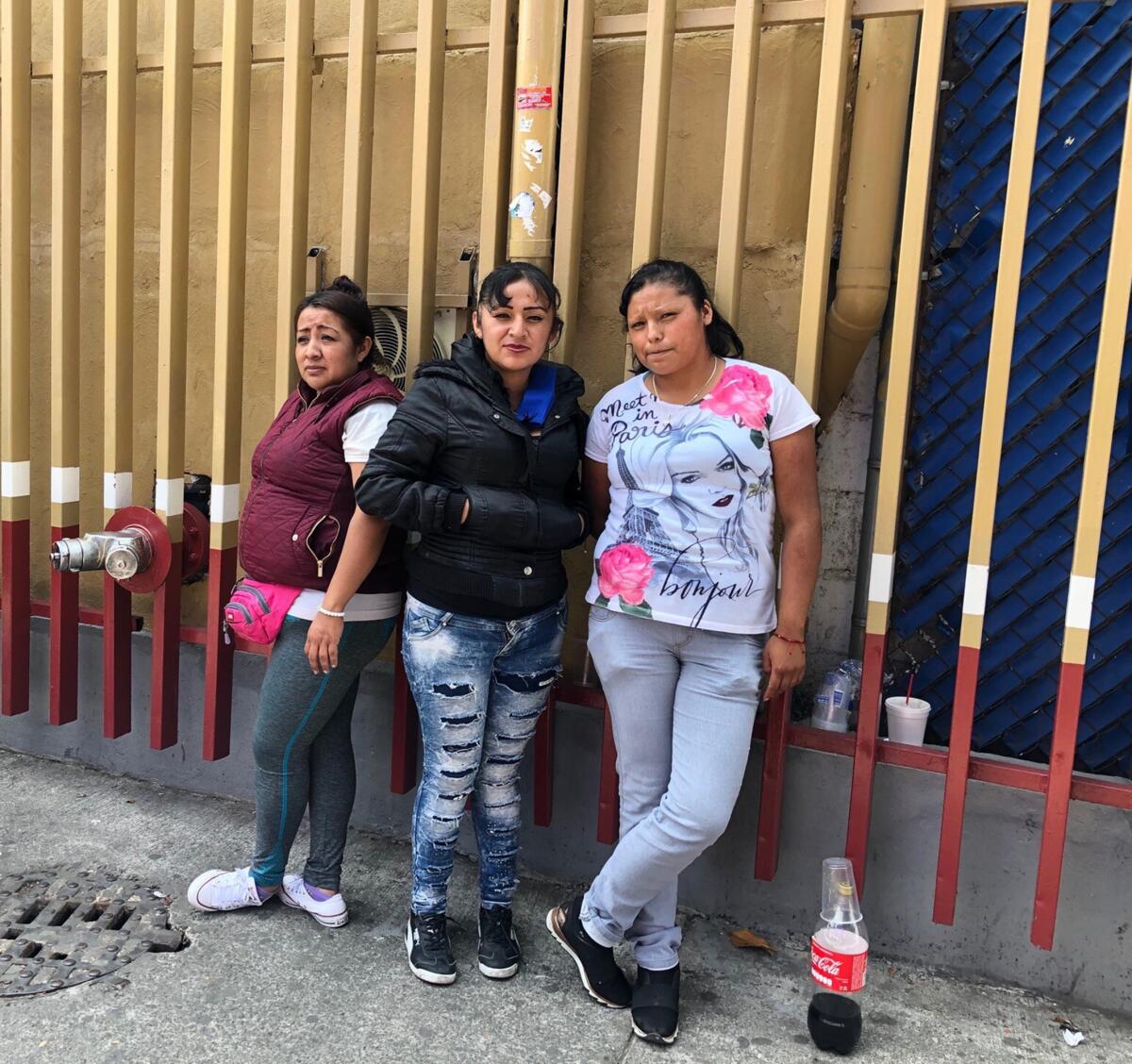 Sisters, from left, Maria, Blanca and Sarai Díaz await news of their brother Julio outside the General Hospital Dr. Eduardo Liceaga in central Mexico City on April 29, 2020. He died the day after he was admitted for COVID-19 symptoms.