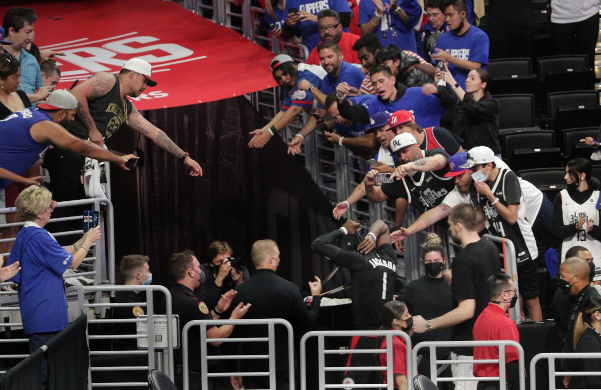 Reggie Jackson gives his jersey to the crowd after the Clippers' loss in Game 6.