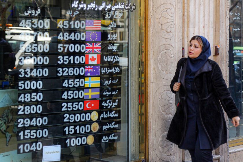 TEHRAN, IRAN - FEBRUARY 22: People follow currency rate from a screen at exchange office after dollar and euro reaches the highest levels in the country's history on February 22, 2023 in Tehran, Iran. The selling rate of the dollar was 45 thousand 200 Iranian toman, while the euro was traded at 48 thousand 200 Iranian toman in the country. (Photo by Fatemeh Bahrami/Anadolu Agency via Getty Images)