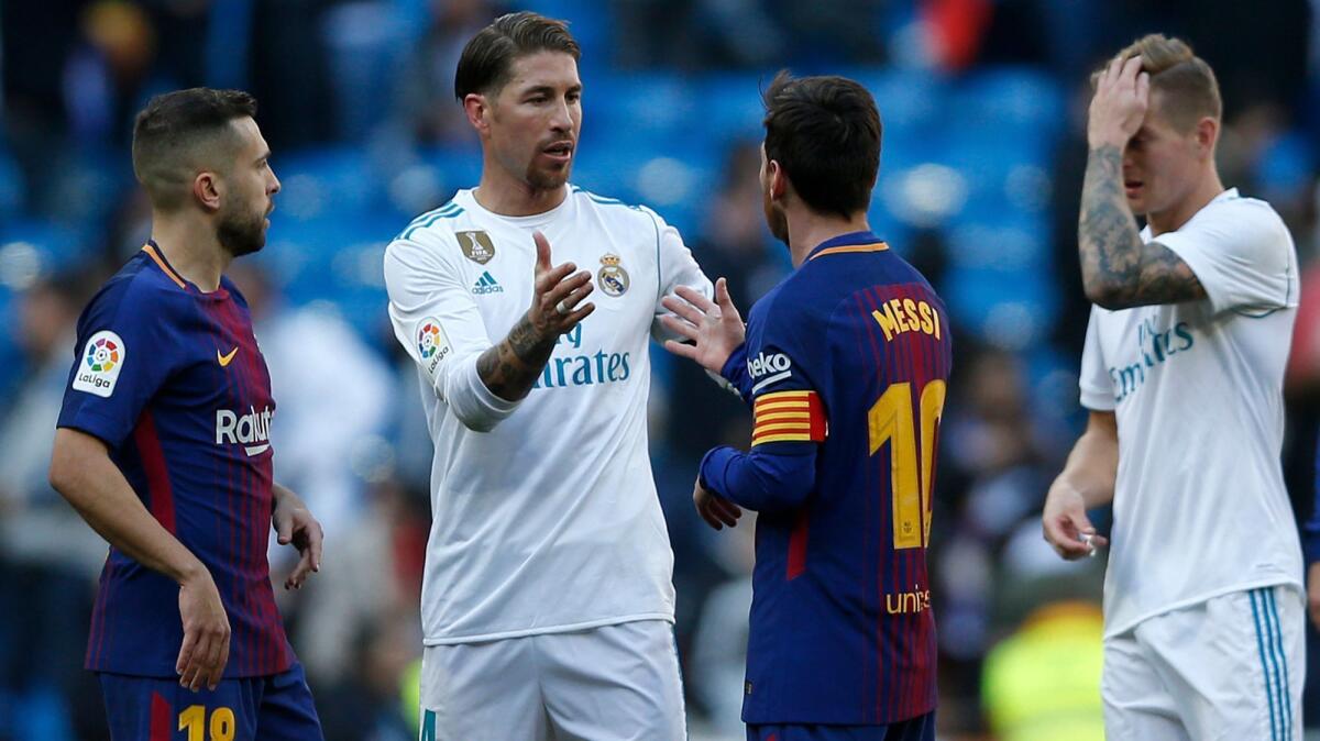 Real Madrid's Sergio Ramos, center left, shakes hands with Barcelona's Lionel Messi at the end of the match between Real Madrid and Barcelona in Madrid on Dec. 23, 2017.