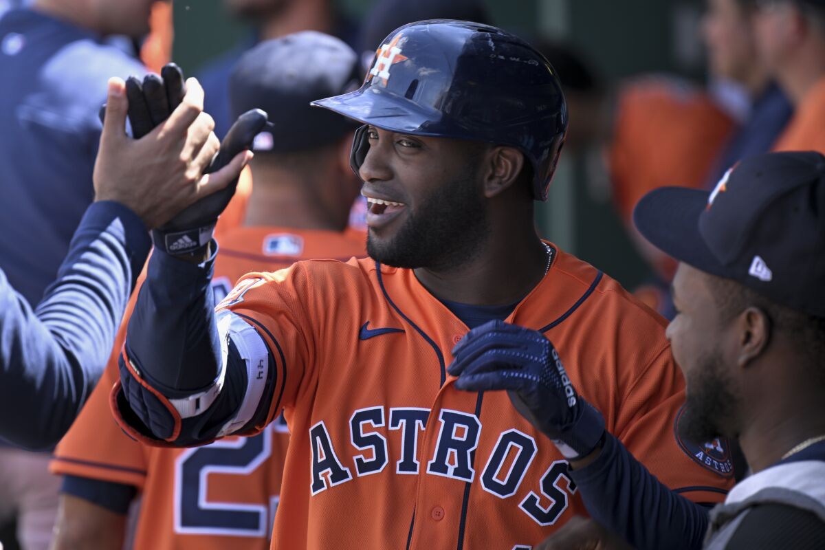 The Houston Astros' Yordan Alvarez is congratulated after hitting a home run during the eighth inning of a baseball game against the Kansas City Royals, Sunday, June 5, 2022, in Kansas City, Mo. (AP Photo/Reed Hoffmann)