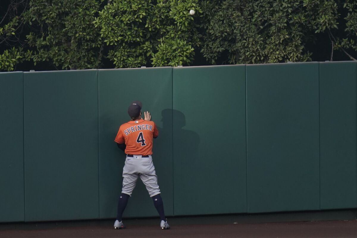 Astros center fielder George Springer watches a ball hit by the Angels' Mike Trout clear the wall Sept. 4, 2020.