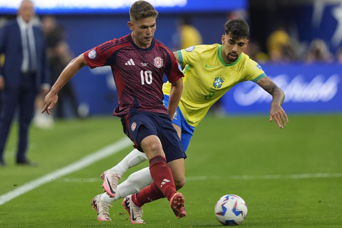 Costa Rica's Brandon Aguilera, left, and Brazil's Lucas Paqueta battle for the ball.