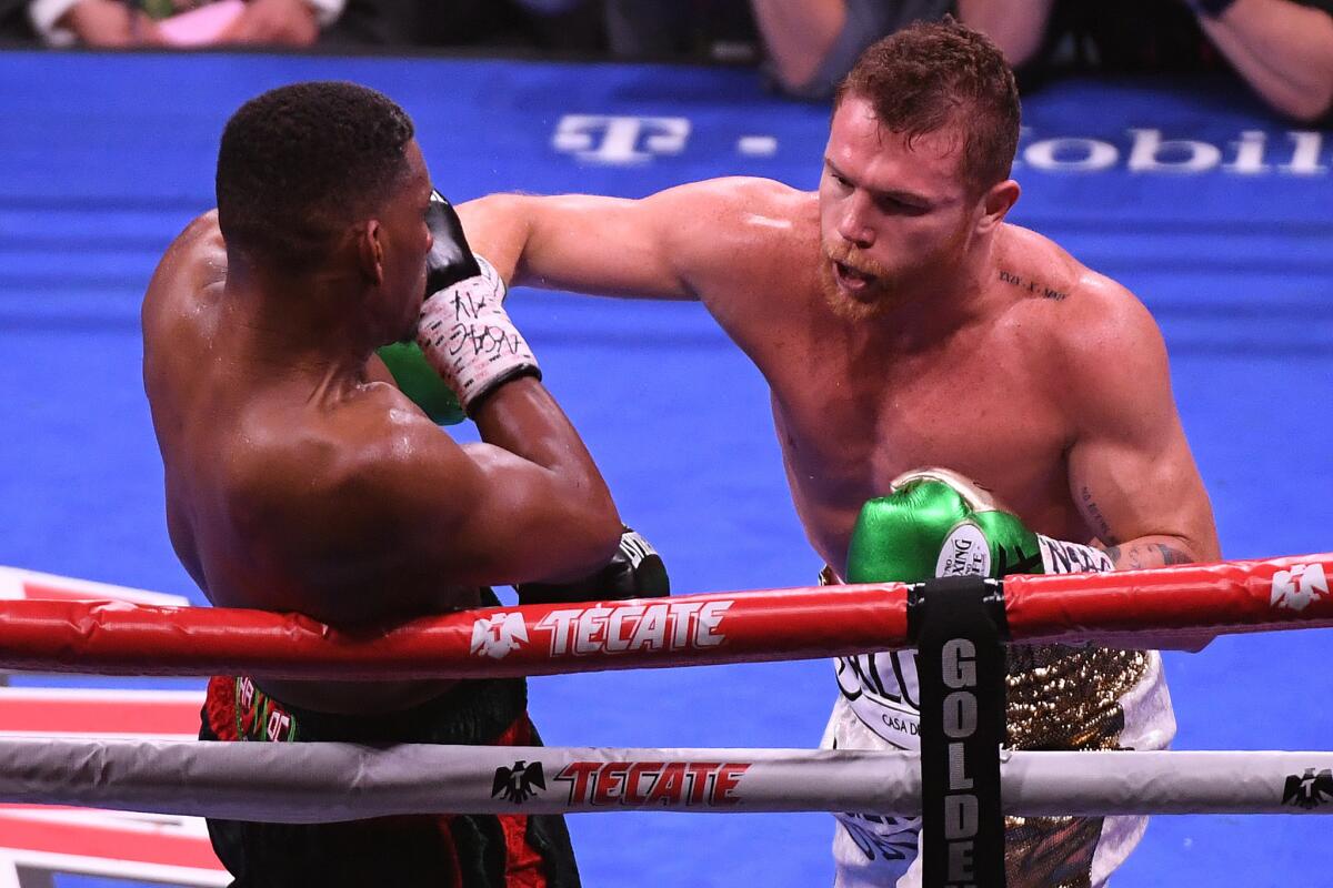 Canelo Alvarez (R) punches Daniel Jacobs during their middleweight unification fight at T-Mobile Arena on May 04, 2019 in Las Vegas, Nevada.