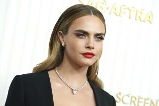 Cara Delevingne, dressed in black with diamong necklace at the 29th annual Screen Actors Guild Awards in LA