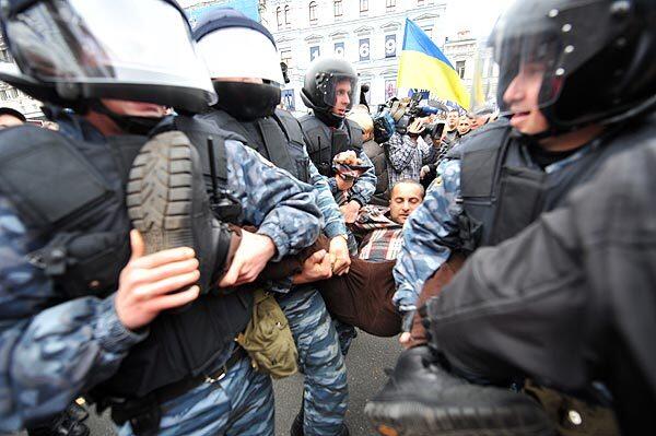 Riot police carry away a supporter of former Prime Minister Yulia Tymoshenko after street clashes broke out on the streets of Kiev between police and Urkainians protesting Tymoshenko's conviction and sentencing to seven years in prison for abuse of power.