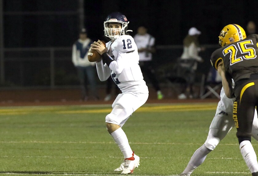 Newport Harbor quarterback AJ Guitron-Moore (12) sets up for a pass against Temecula Valley.