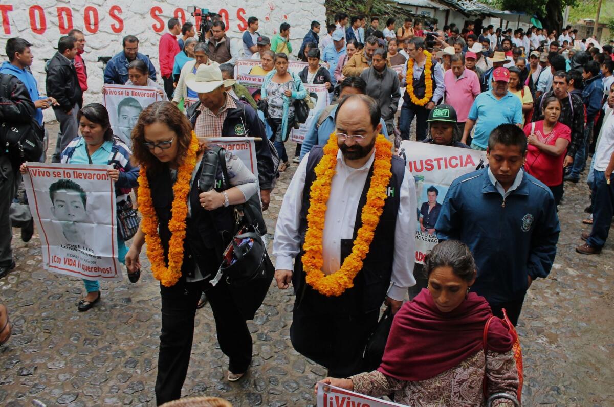 Rose-Marie Belle Antoine, president, and Emillio Alvarez Icaza, executive secretary, of the Inter-American Commission on Human Rights, are received by parents and relatives of the 43 missing students at Ayotzinapa in the southern state of Guerrero on Sept. 29, 2015.