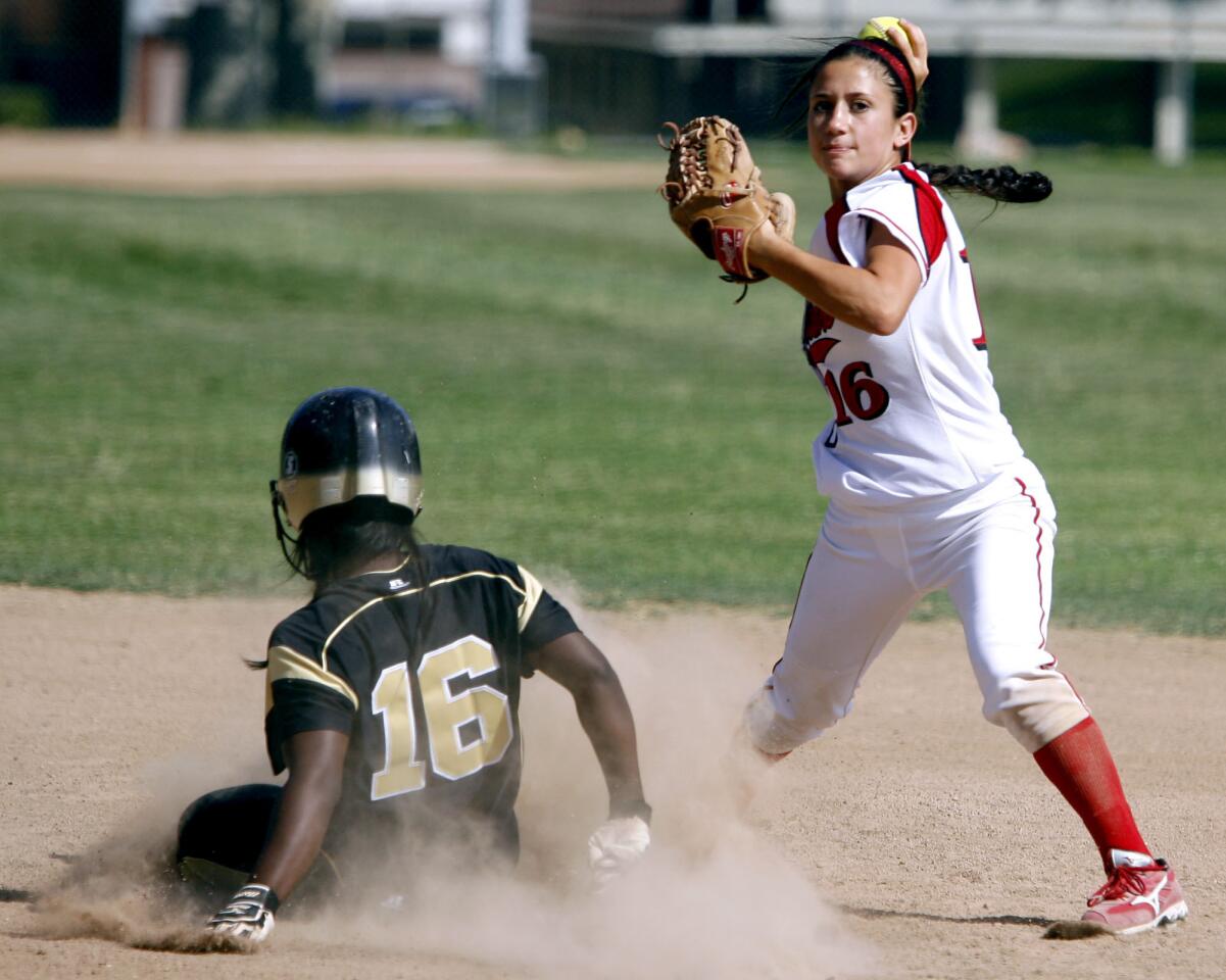 Burroughs High School's #16 Caitlin Loera gets the runner out at 2nd base before throwing to 1st base during CIF SS Div III softball first round playoff game at home vs. Knight High School in Burbank on Thursday, May 18, 2012.
