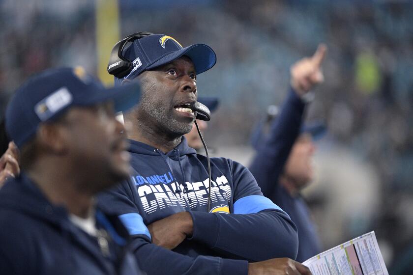 Los Angeles Chargers head coach Anthony Lynn, center, reacts on the sideline after a replay is shown on a stadium video monitor during the second half of an NFL football game against the Jacksonville Jaguars Sunday, Dec. 8, 2019, in Jacksonville, Fla. (AP Photo/Phelan M. Ebenhack)