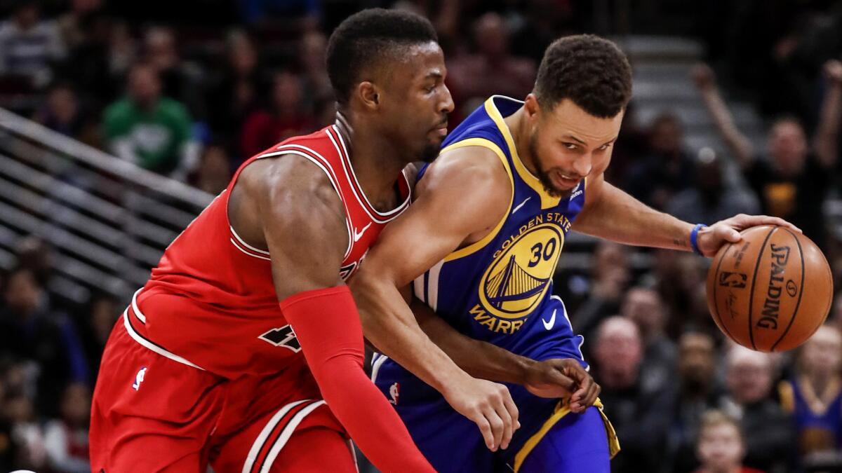 Bulls guard David Nwaba tries to cut off a drive by Warriors All-Star Stephen Curry during a game Jan. 17.