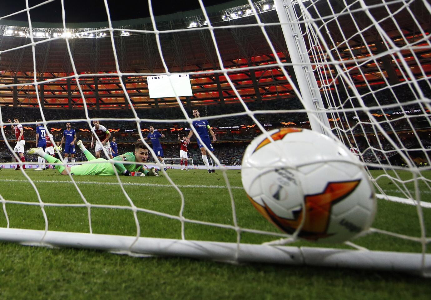 Chelsea goalkeeper Kepa Arrizabalaga, on the ground, looks at the ball after a goal from Arsenal's Alex Iwobi during the Europa League Final soccer match between Chelsea and Arsenal at the Olympic Stadium in Baku, Azerbaijan, Thursday, May 30, 2019. (AP Photo/Darko Bandic)
