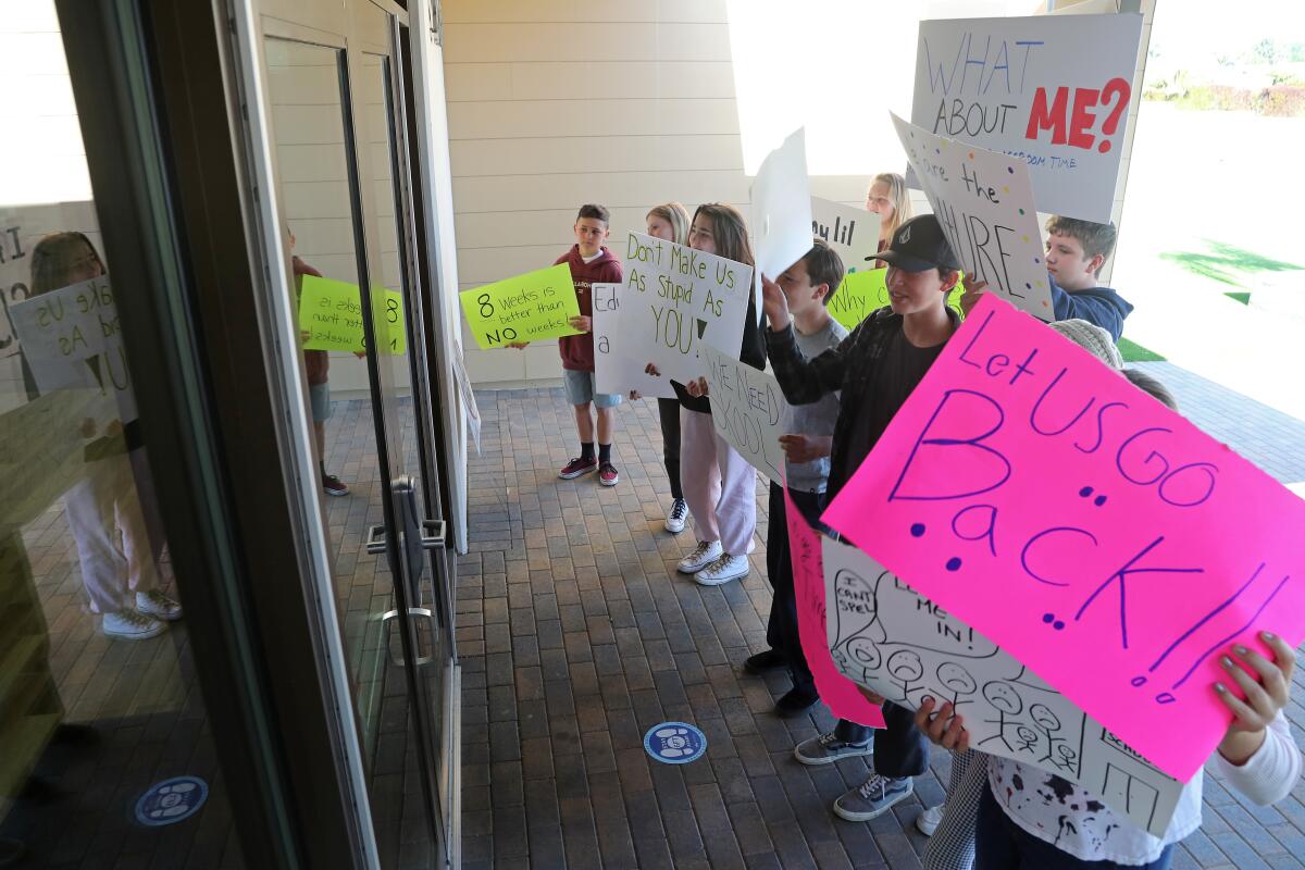 Students protest in front of the Huntington Beach City School District office on Wednesday morning.