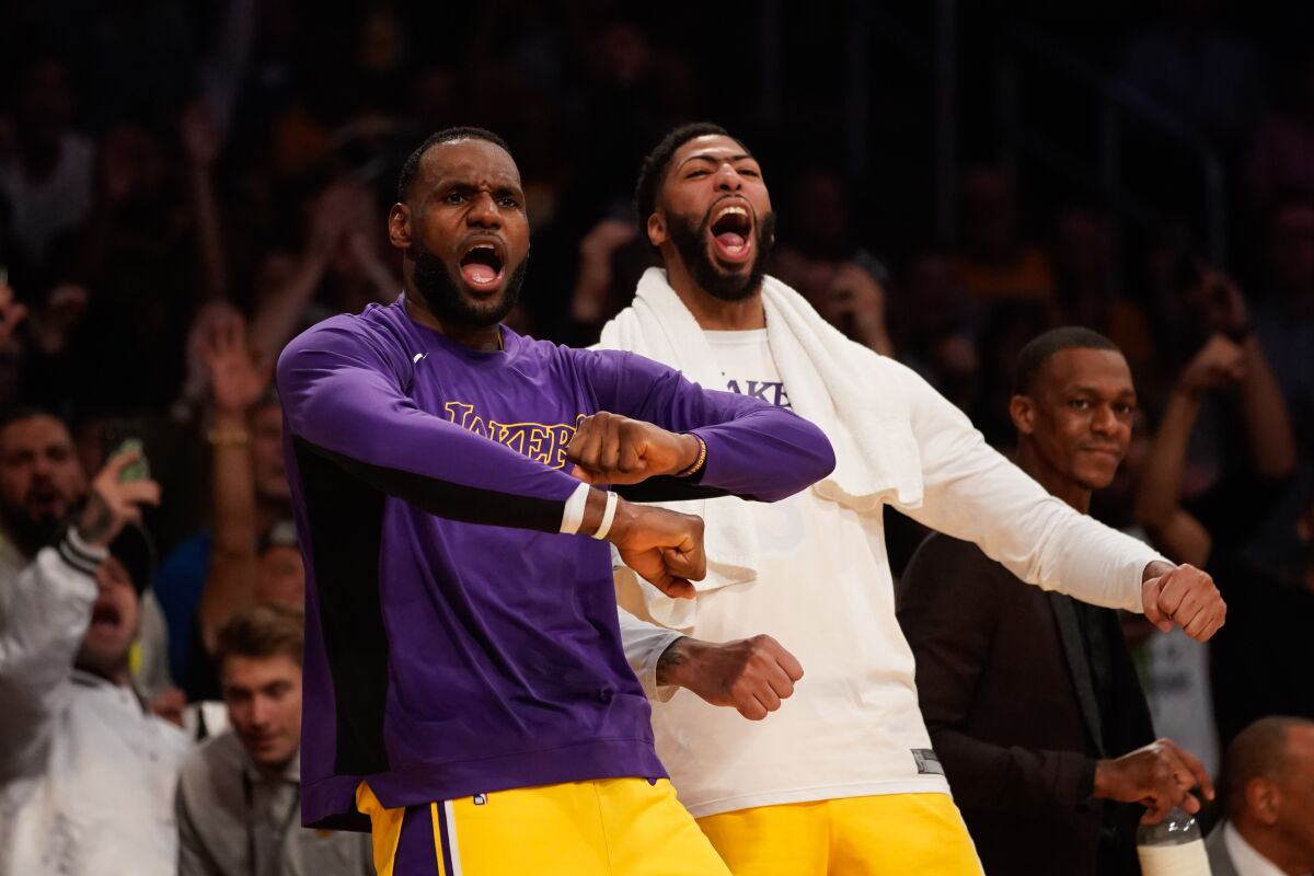 Lakers forward LeBron James (23) and forward Anthony Davis (3) cheer during a game against the Memphis Grizzlies at Staples Center on Tuesday.
