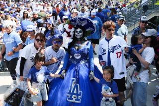 LOS ANGELES, CA - MARCH 28: La Muerta Maria wears a stands with fans before the game.