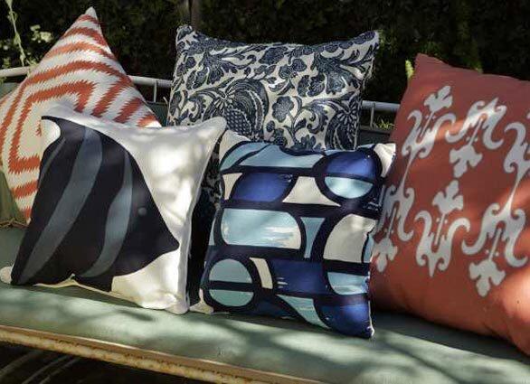 Throw pillows in weather-resistant outdoor fabrics pack a punch this summer.