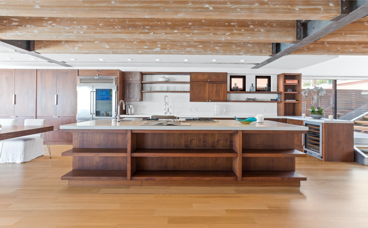 The architectural beach house expands to two levels of wood decks overlooking the ocean.
