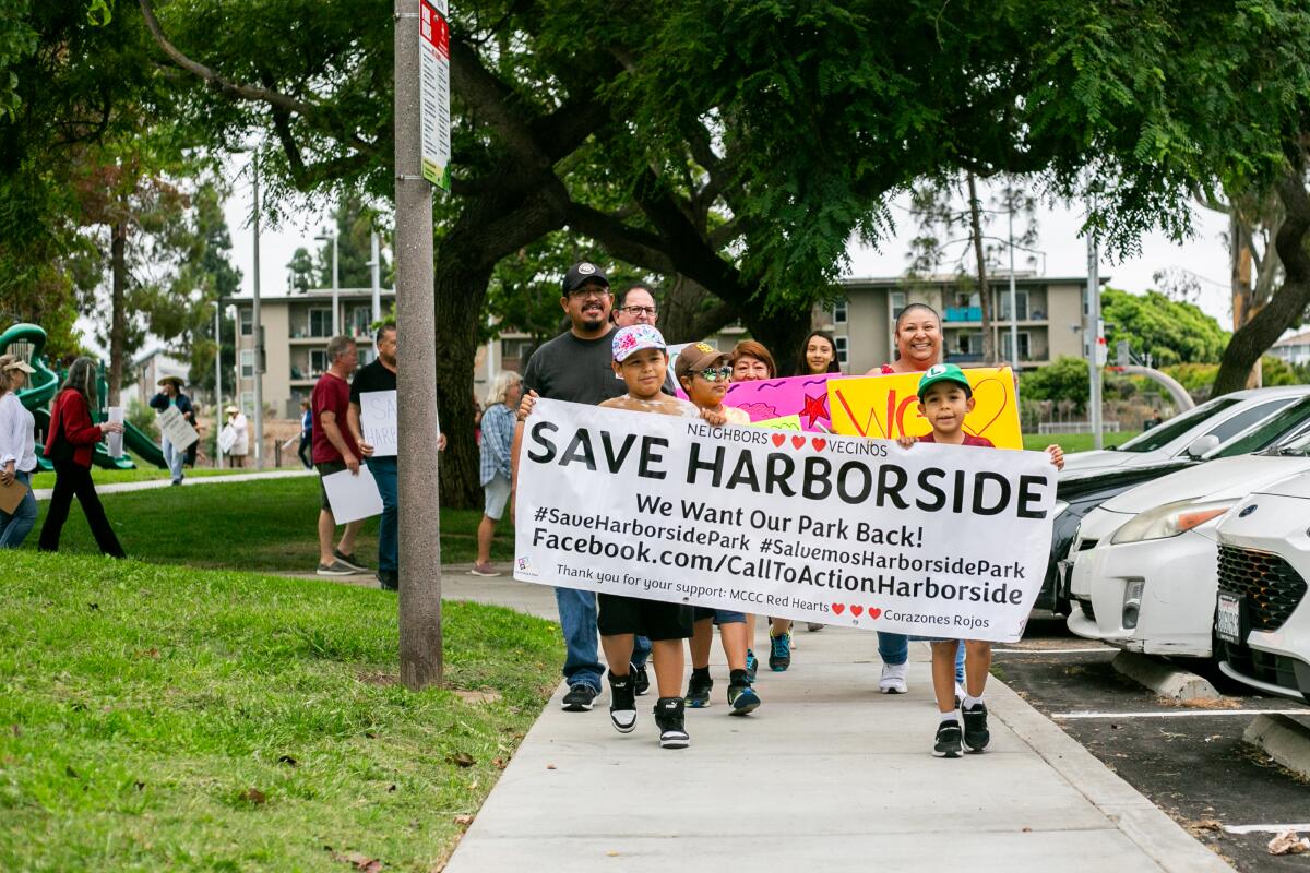 Javier Torres, left, and Josue Torres, right, lead the march to Harborside Park