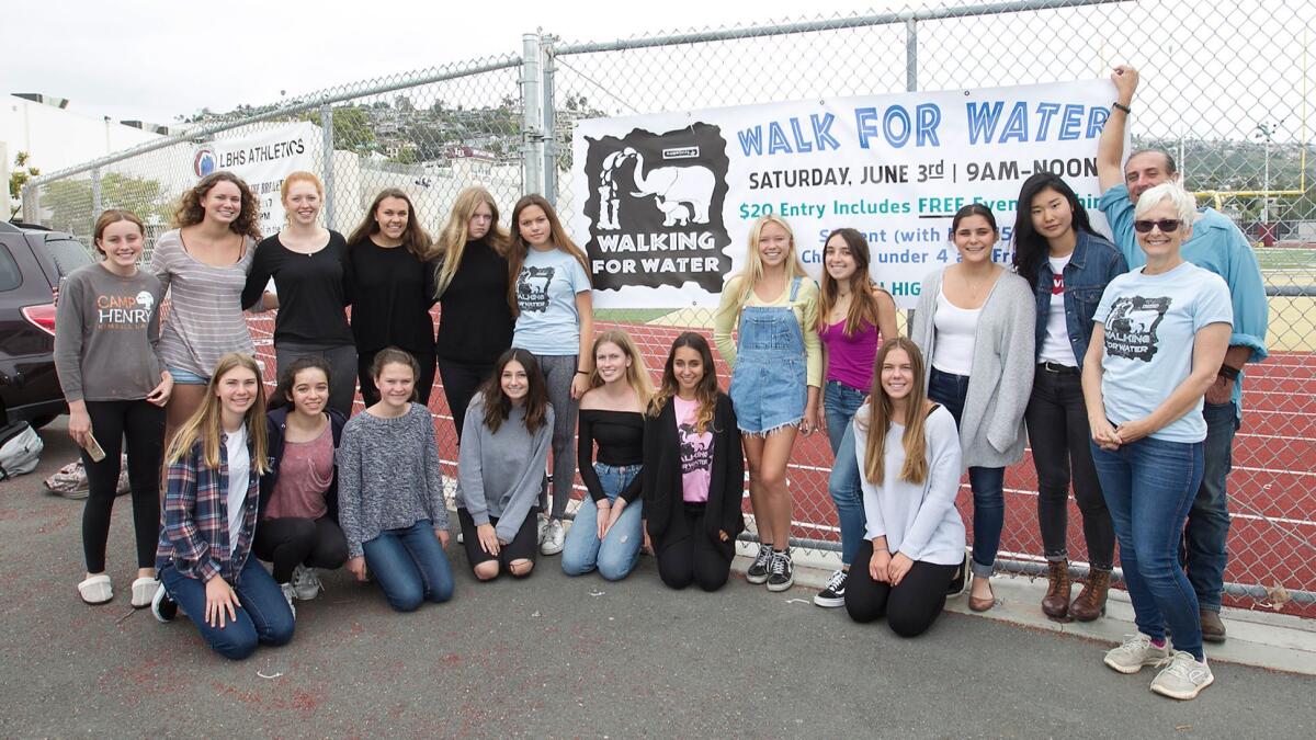 Susan Hough, right, board president of Wisdom Spring, stands with students from Laguna Beach High School's Walking for Water Club who will participate in the fundraising walk Saturday. The students have partnered with Wisdom Spring for the walk.