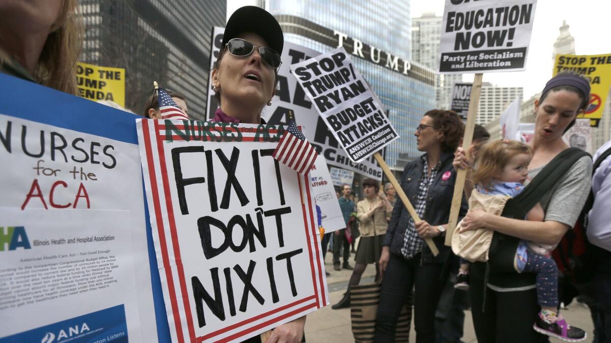 Protesters across the Chicago River from Trump Tower rally against the repeal of the Affordable Care Act. (Charles Rex Arbogast / Associated Press)