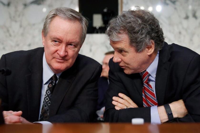 Chairman of the Senate, Housing, and Urban Affairs Committee Sen. Michael Crapo, R-Idaho, left, and ranking member Sen. Sherrod Brown, D-Ohio, talk before Jerome Powell, President Donald Trump's nominee for chairman of the Federal Reserve, testifies during a Senate Banking, Housing, and Urban Affairs Committee confirmation hearing on Capitol Hill in Washington, Tuesday, Nov. 28, 2017. (AP Photo/Carolyn Kaster)