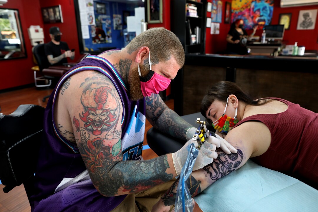 Andrew Wagner applies an octopus tattoo to Jordan Curiel in Yuba City.