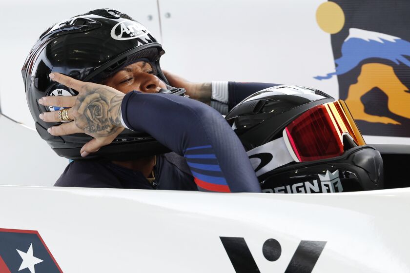 Driver Kallie Humphries, right, reaches back to congratulate Jasmine Jones of the United States on their run in the two-woman bobsled World Cup race Saturday, Dec. 3, 2022, in Park City, Utah. (AP Photo/Jeff Swinger)