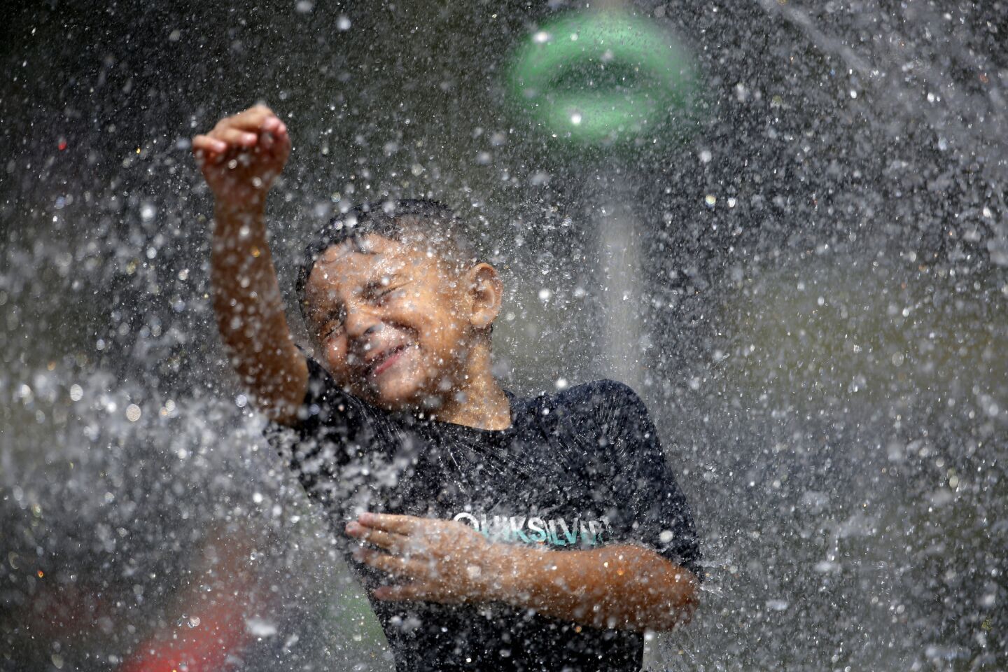 Anthony Garcia, 7, cools off at the splash pad at Rio de Los Angeles State Park in Los Angeles.