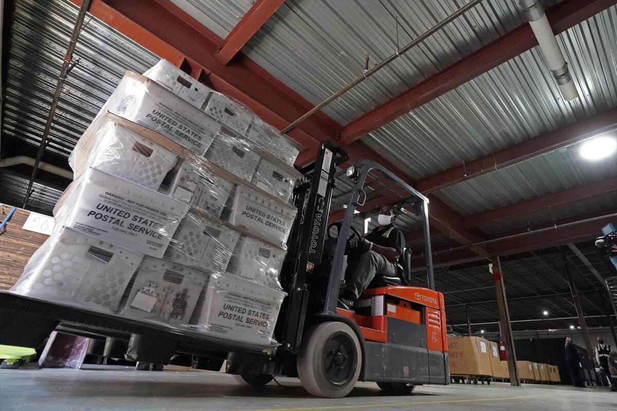 A forklift operator loads absentee ballots for mailing in Raleigh, N.C.