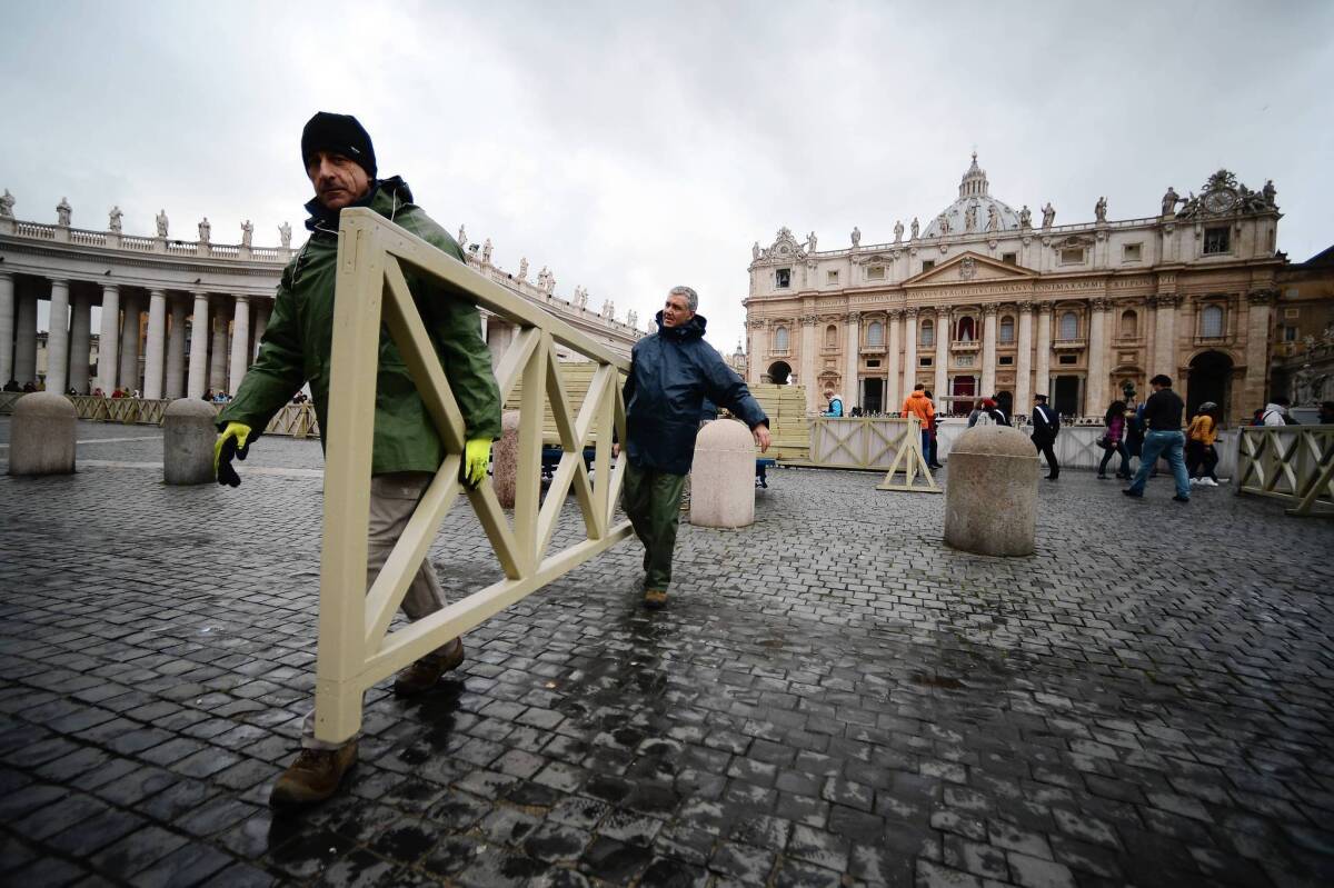 Workers prepare St. Peter's Square for the pope's inauguration Mass at the Vatican.