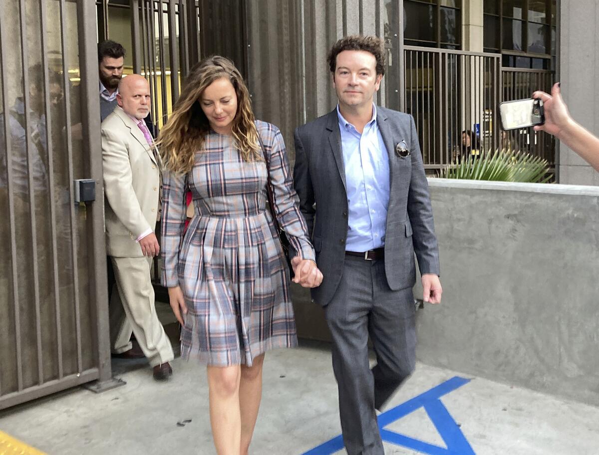 Danny Masterson leaves a courthouse holding hands with Bijou Phillips.