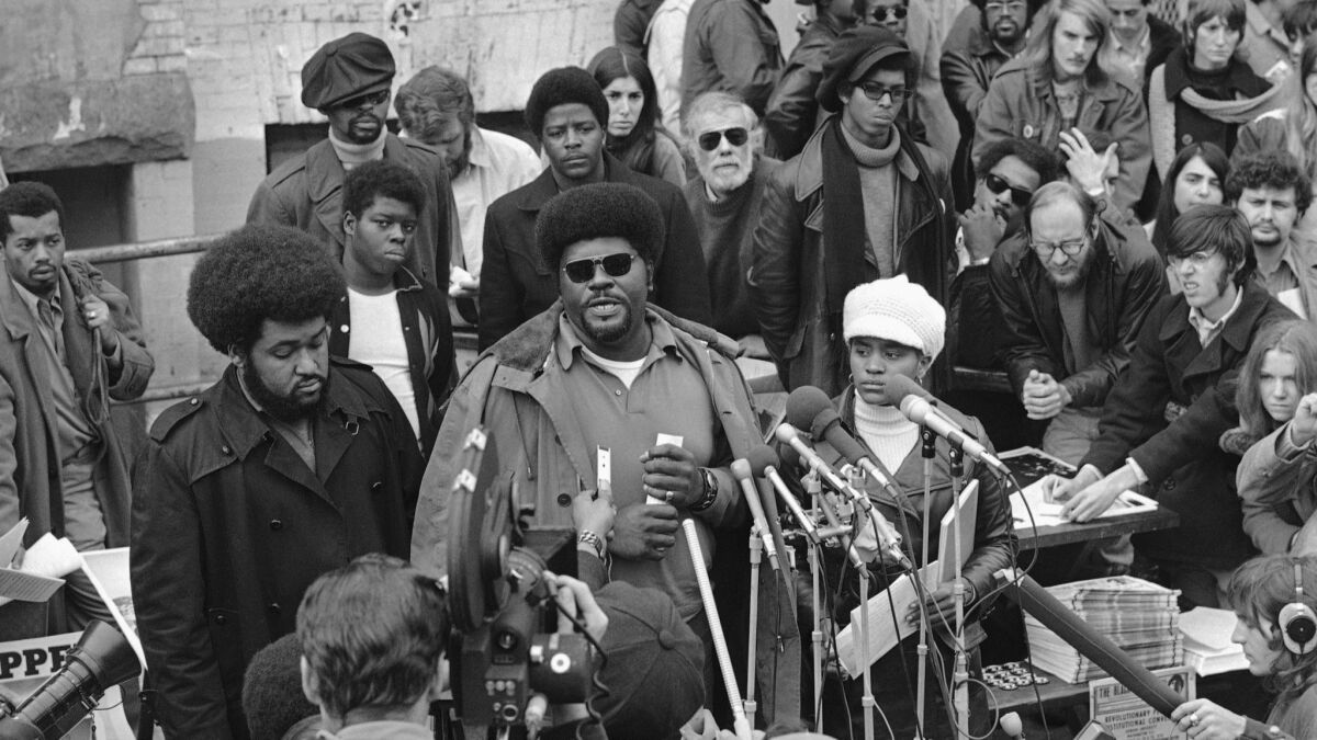 In this Nov. 27, 1970, file photo, Elbert "Big Man" Howard speaks at a sidewalk news conference in Washington.