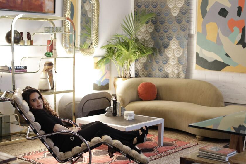 LOS ANGELES, CA -- MAY 06, 2019: Tricia Beanum, reclining on a Ludwig Mies van der Rohe chaise lounge, has built her estate sale business into a hip LA phenomenon frequented by set decorators, designers and high end stores. Beanum holds estate sales for celebrities and folks with high-end homes all over the city. Her clients are usually anonymous but sometimes allow her to market their names ? Adam Levine, Camille Grammer. Her warehouse store Pop Up Home on Jefferson in West Adams changes constantly and features fair prices and some steep discounts. ?I don?t want it to feel like an established retail store,? she says. ?I?m a hunter. I?m inspired by what people collect.? (Myung J. Chun / Los Angeles Times)