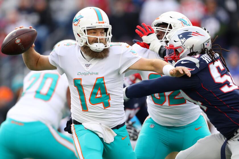 FOXBOROUGH, MASSACHUSETTS - DECEMBER 29: Ryan Fitzpatrick #14 of the Miami Dolphins looks to pass against the New England Patriots at Gillette Stadium on December 29, 2019 in Foxborough, Massachusetts. (Photo by Maddie Meyer/Getty Images)