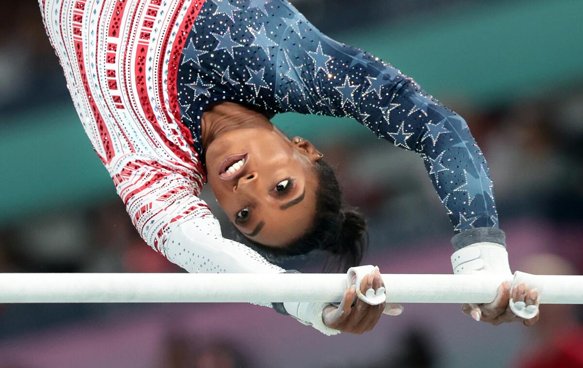 Simone Biles competes on the uneven bars.