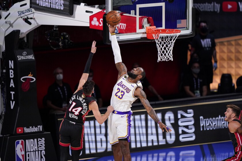 Lakers forward LeBron James blocks a shot by Heat guard Tyler Herro during Game 3.