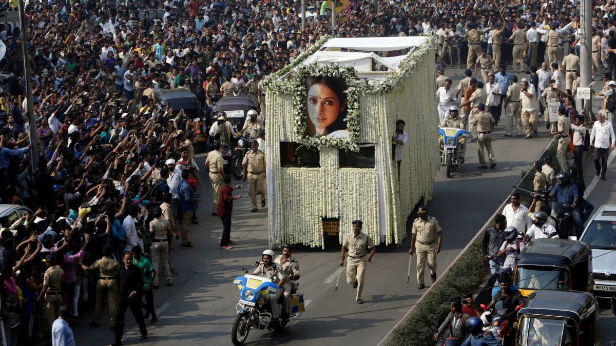 Crowds fill the streets in Mumbai, India, as the body of Indian actress Sridevi is transported from a viewing at a private club to a crematorium on Wednesday.
