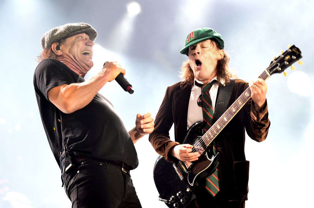 Brian Johnson, left, and Angus Young of AC/DC perform Monday night at Dodger Stadium in Los Angeles.