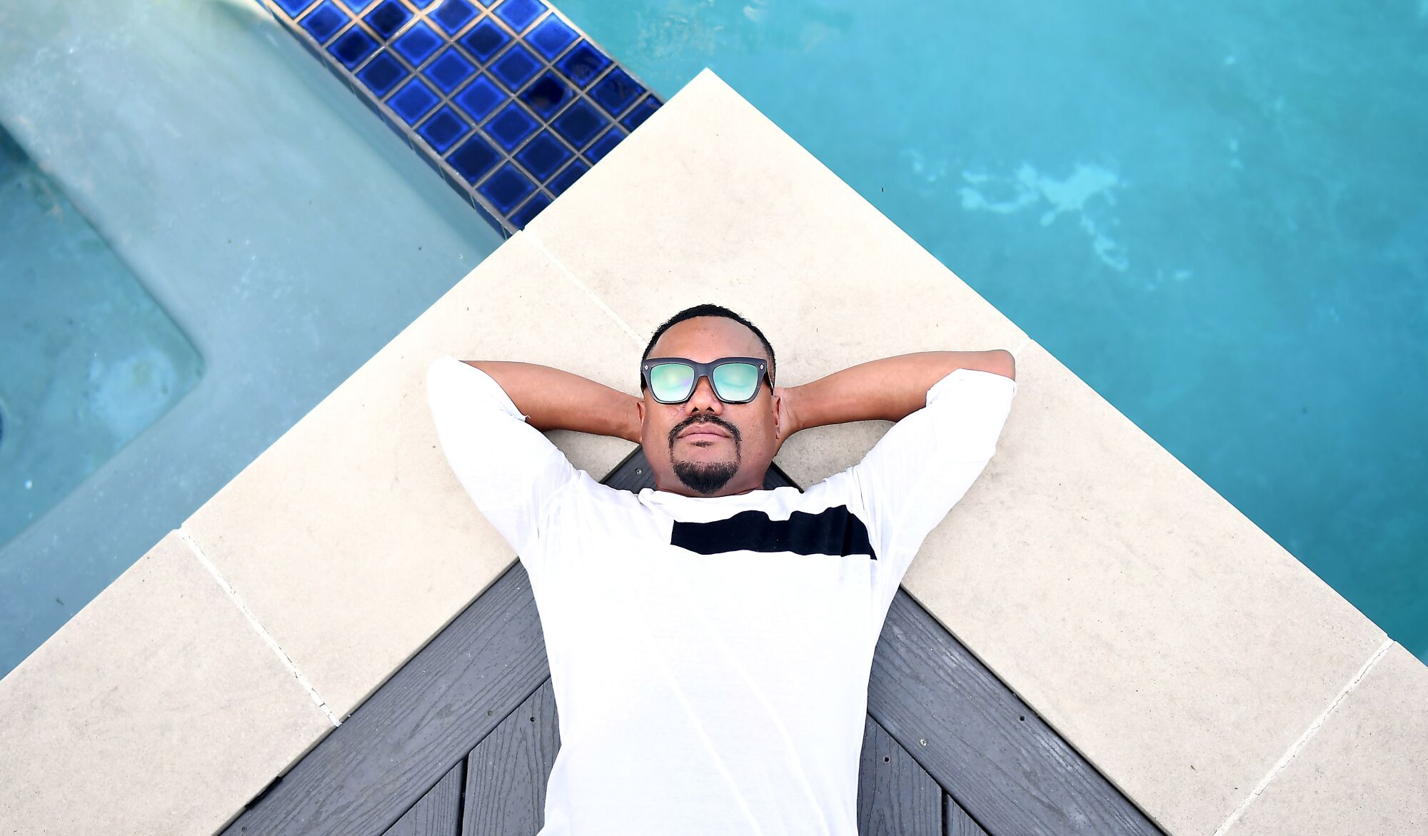 Apl.de.Ap of the Black Eyed Peas by his pool in the Valley.