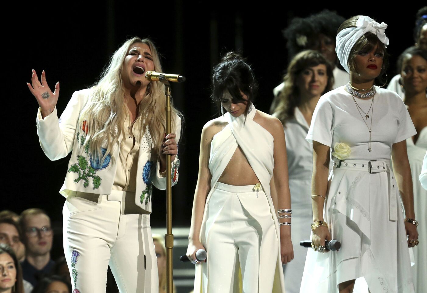 Kesha, left, performs "Praying" as Camila Cabello, center, and Andra Day stand by.