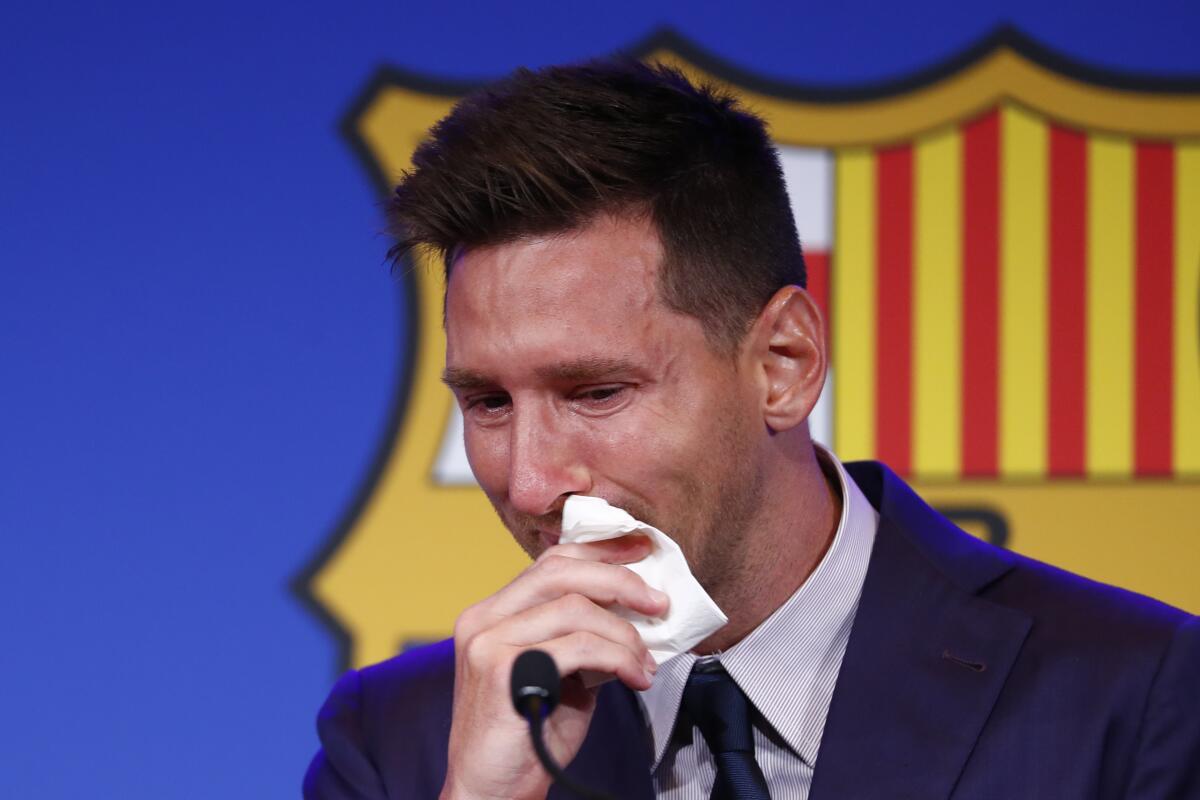 Lionel Messi cries at the start of a press conference at the Camp Nou stadium in Barcelona