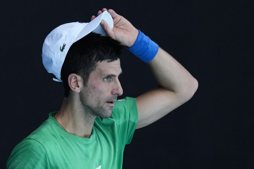 Defending men's champion Serbia's Novak Djokovic practices on Margaret Court Arena.
