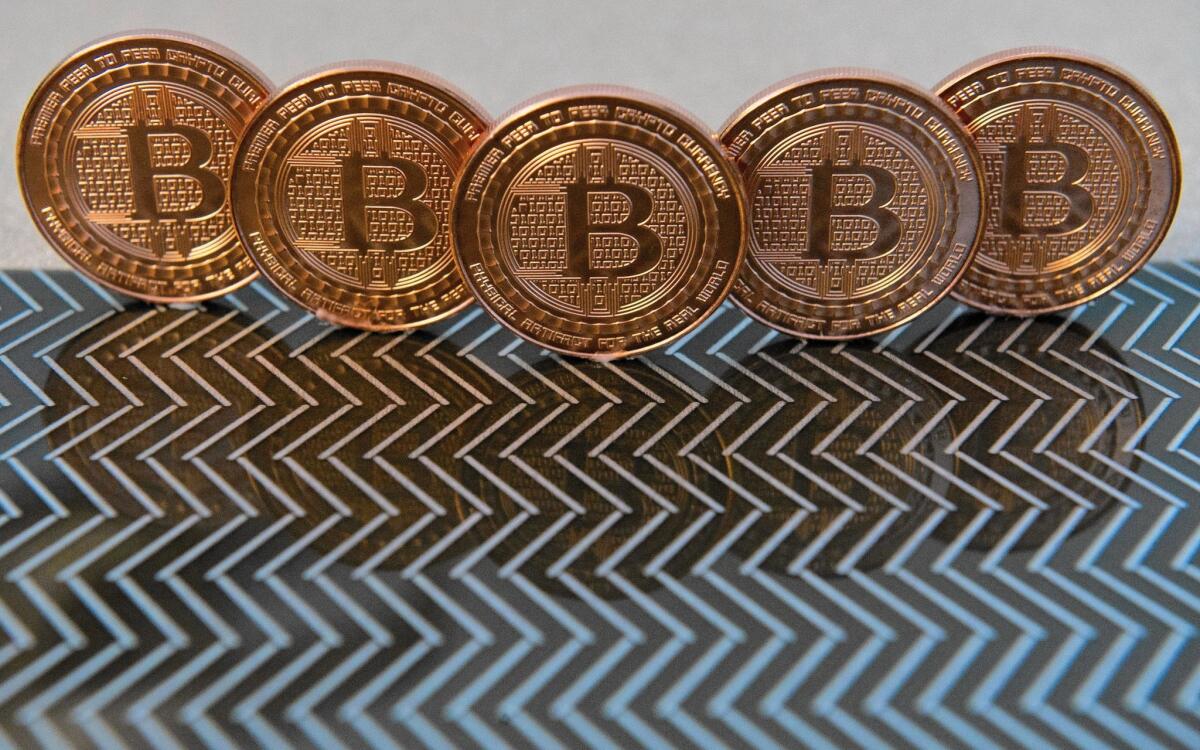 ItBit Trust Co., a New York start-up that allows investors to trade dollars for bitcoins, started operating Thursday under a banking trust charter that it says allows it to function legally in all 50 states. Above, bitcoin medals.