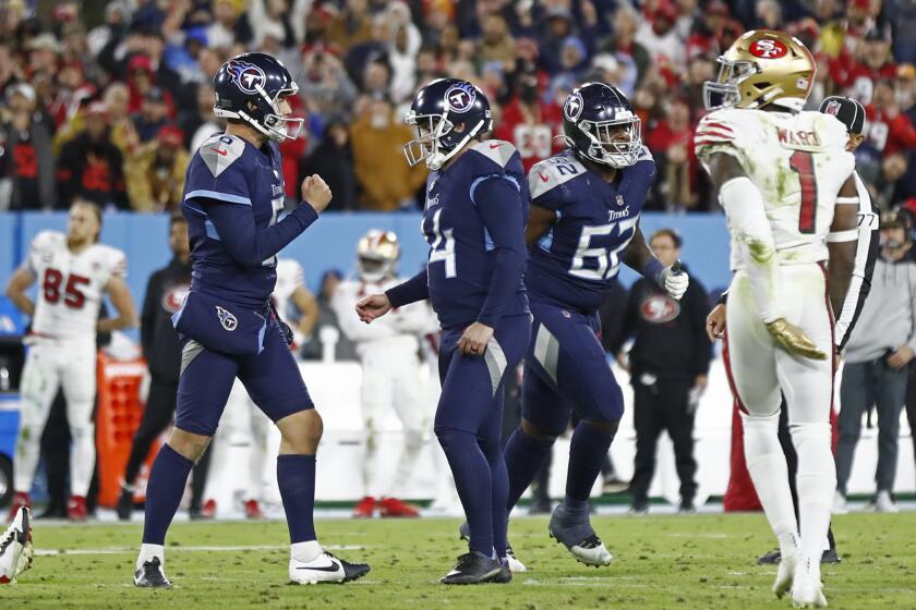 Tennessee Titans kicker Randy Bullock (14) celebrates with holder Brett Kern, left, after Bullock kicked a 44-yard field goal in the final seconds of the fourth quarter of an NFL football game against the San Francisco 49ers Thursday, Dec. 23, 2021, in Nashville, Tenn. The field goal gave the Titans a 20-17 win. (AP Photo/Wade Payne)