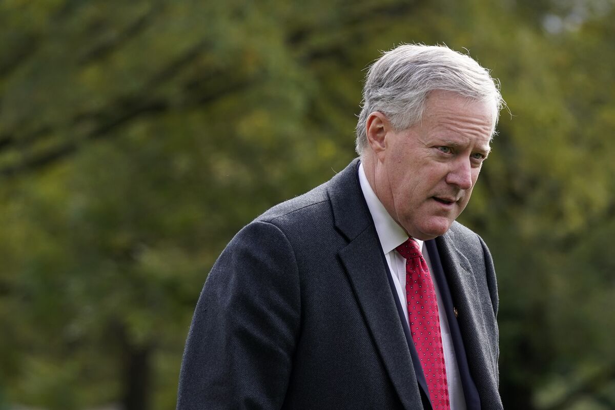 FILE - Then-White House chief of staff Mark Meadows walks on the South Lawn of the White House in Washington, Oct. 30, 2020. An elections board in a North Carolina county has removed Meadows from its list of registered voters after documents showed he lived in Virginia and voted in the 2021 election in that state. Questions arose about Mark Meadows last month, when North Carolina Attorney General Josh Stein’s office asked the State Bureau of Investigation to look into Meadows’ voter registration in Macon County in western North Carolina. In announcing his removal, the Macon County Board of Elections said it has received no formal challenge and is referring the matter to the SBI, the state Board of Elections said Wednesday, April 13, 2022. (AP Photo/Patrick Semansky)