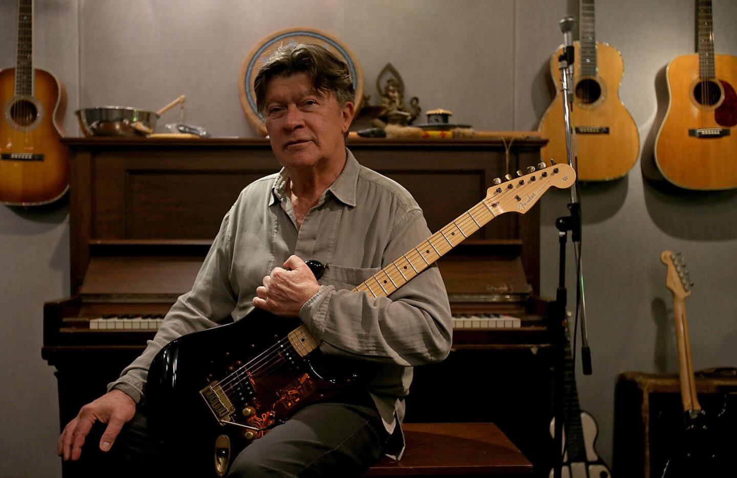 Robbie Robertson, lead guitarist for the Band, holds a recent incarnation of the Fender Stratocaster electric guitar, a music industry standard that is celebrating its 60th anniversary this year.