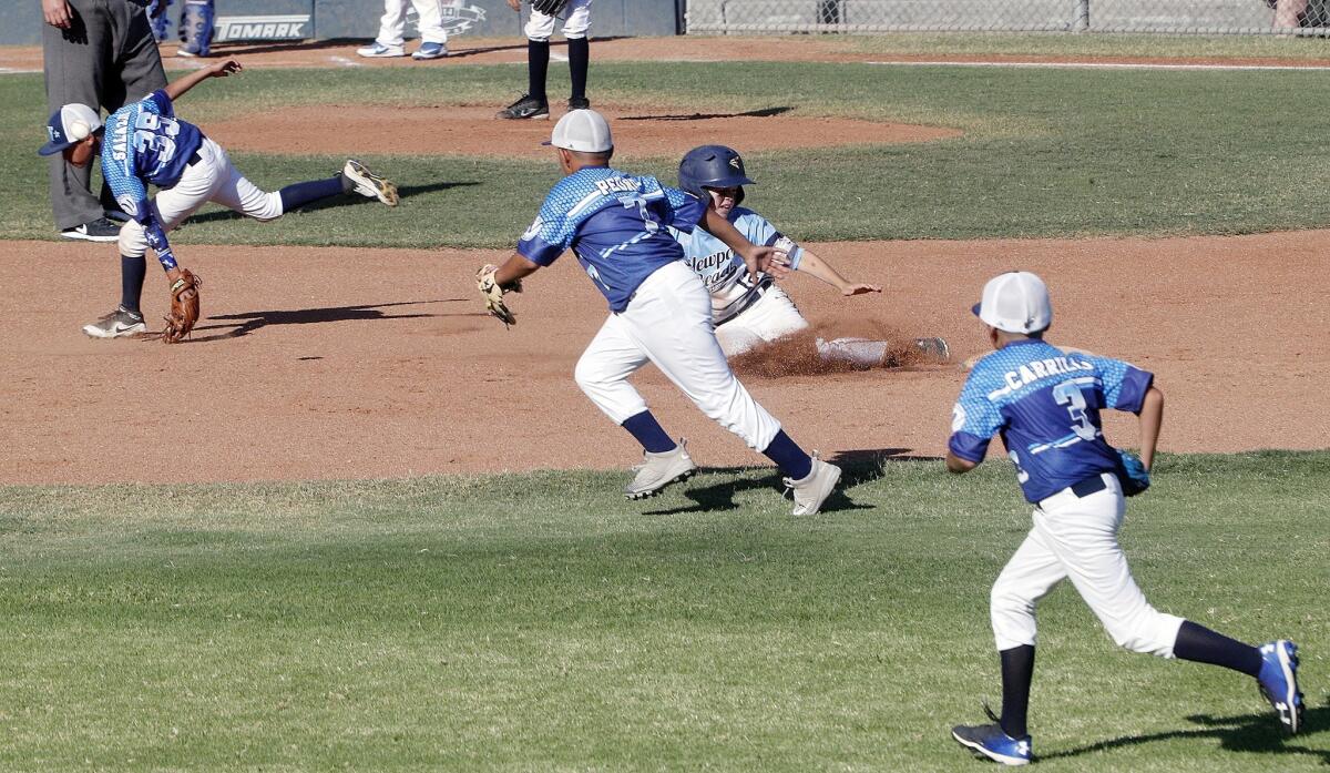 Newport Beach's Brady Andrews slides safely into second base with a steal as the Walnut Valley infield chases the throw from home in a PONY Bronco 11-and-under West Zone tournament game at Creekside Park in Walnut on Friday.
