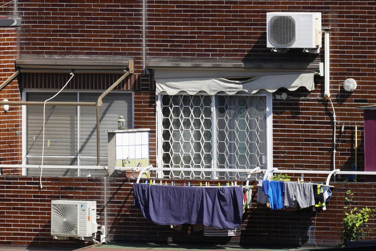 Air-conditioning external units are seen on the facade of a building in Rome